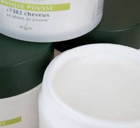 Close-up of open white jar of hair mask.