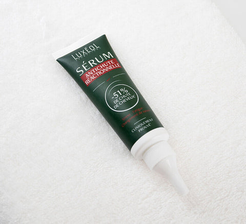 Serum tube on towel close‑up highlighting precision tip applicator.