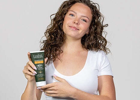 lady holding shampoo in hands