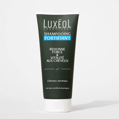 Luxéol Strengthening Shampoo 200 ml tube on minimal background for strength and vitality.

